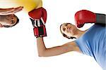 Determined female boxer focused on her training over white background