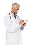 Concentrated male doctor writing reports over white background