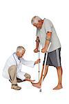 Side view of a doctor with senior man using walker over white background