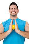 Portrait of a content young man holding stress ball over white  background