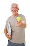 Portrait of a cheerful senior man with an apple and scales over white background