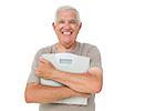 Portrait of a cheerful senior man with scales over white background