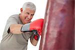 Portrait of a determined senior boxer over white background