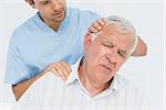 Male chiropractor doing neck adjustment in the medical office