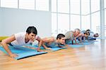 Fitness group doing push ups in row at the yoga class
