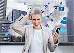 Digital composite of angry businesswoman holding smartphone with cloud computing graphic
