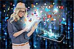 Digital composite of stylish blonde using tablet pc with app icons and smartphone