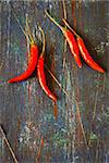 Hot red chili on an old wooden board. Vintage style. Toned photo.