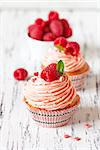 Sweet cupcakes with fresh raspberry and mint.