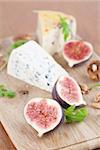 Cheese board with blue cheese, nut cheese, fresh figs and nuts