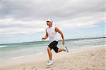 man is jogging on the beach summertime sport fitness run jogger runner