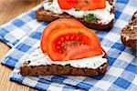 Sandwich with cream cheese and tomato on a bread