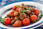 Roasted mushrooms with cherry tomatoes on a plate