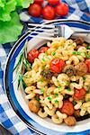 Pasta with roasted mushrooms and cherry tomatoes on a plate