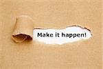 Make it happen! appearing behind torn brown paper.