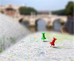 Push pins pointing planned travel destinations on tourist map, blurred background