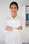 Casual businesswoman smiling at camera in her office