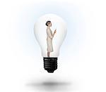 Thinking businesswoman in light bulb on white background