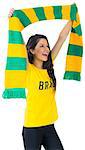 Excited football fan in brasil tshirt on white background
