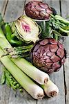 Artichoke, leek, beans, pea, asparagus and green hot pepper on old wood table