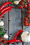 Chili pepper, cherry tomato, cilantro and garlic - traditional ingredients of mexican cuisine. Copyspace background.