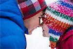 Brother and sister face to face in snow