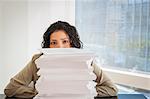 Portrait of businesswoman with a stack of paperwork