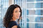 Portrait of young businesswoman in front of window