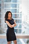 Portrait of young businesswoman with arms folded