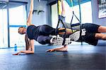 Couple doing side plank exercise