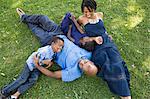 Mature couple with son and daughter relaxing in park