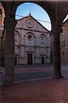 View of Pienza Cathedral through archway, Pienza, Val d'Orcia, Province of Siena, Tuscany, Italy