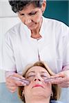 Doctor doing Crystal Therapy on Senior Patient in Doctor's Office
