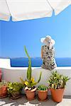 Woman on steps in town of Oia, Santorini, Kyclades, South Eagean, Greece,Europe  Model release 0009