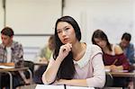Focused asian student listening in class at the university