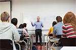 Students listening to lecturer at top of class at the university