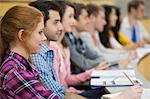 Row of students listening in a lecture hall in college