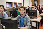 Cheerful students listening in their computer class at the university