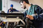 Instructor checking a machine in workshop