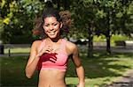 Portrait of a beautiful healthy young woman jogging in the park