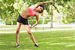 Full length of a toned and flexible woman doing stretching exercise in the park