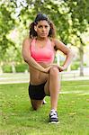 Full length of a toned and flexible woman doing stretching exercise in the park