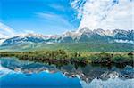 Mirror Lakes are a famous natural landmark omn the Milford Road in the Fiordland National Park. Snowy mountains are reflecting in a calm water. New Zealand