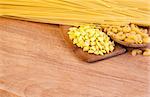 pasta and wooden spoon on a wooden board