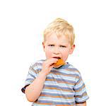 Cute little boy eating delicious cookie isolated on white background