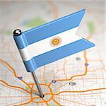 Small Flag of Argentina Sticked in the Map Background with Selective Focus.