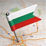 Small Flag of Bulgaria Sticked in the Map Background with Selective Focus.