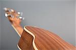 Close-up shot of classic ukulele guitar, back view, selective focus