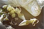 Wedding shoes with bouquet of white roses  on chair