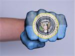 Very hairy knuckles from the fist of a man punching, presidential seal